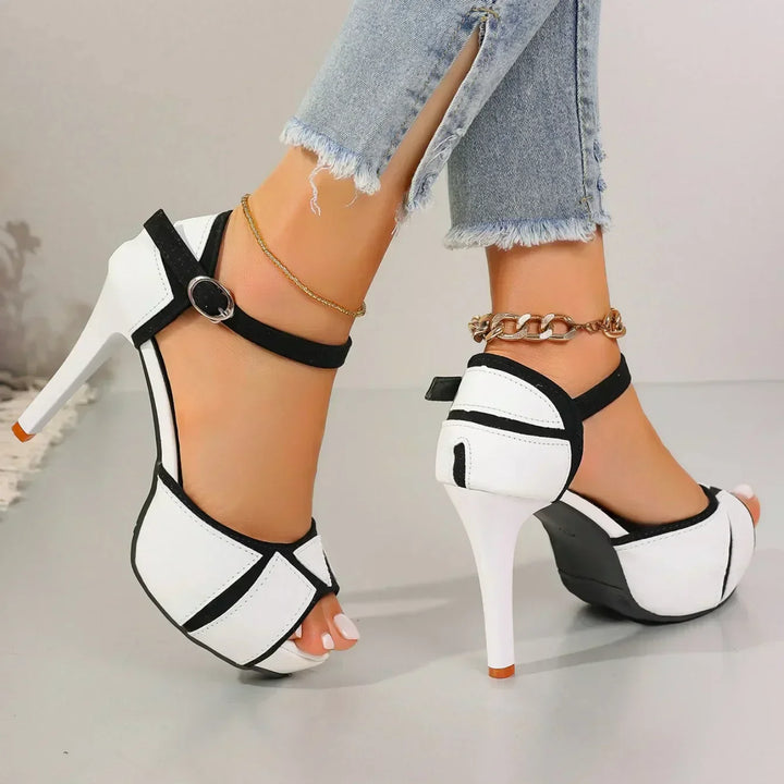 White-and-black ankle-strap platform heels with open toe and high stiletto heel