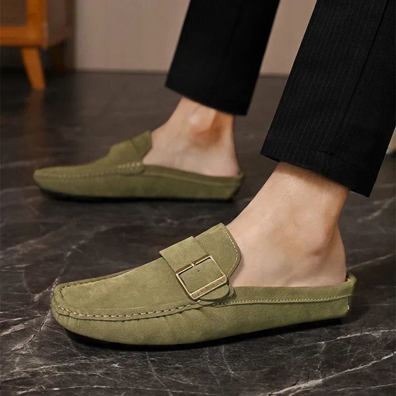 Olive green suede mules with square buckle strap and rounded moc toe, slip-on