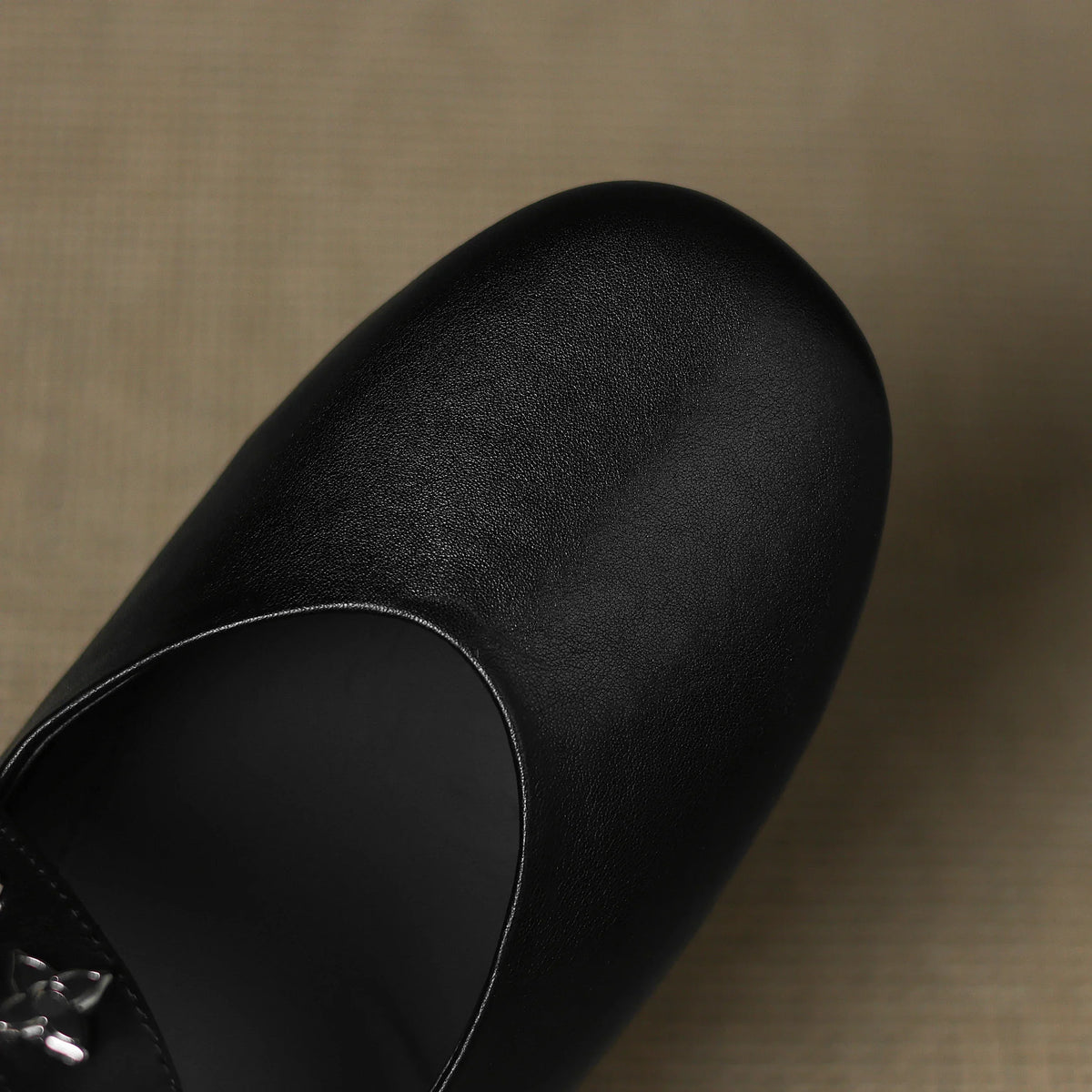 Black leather flat with smooth rounded toe and curved topline seam