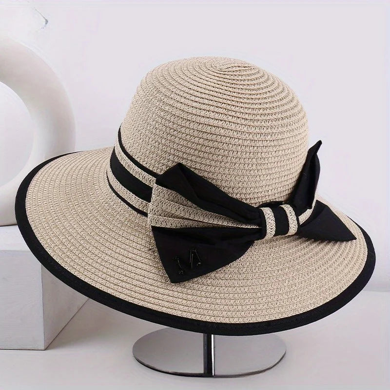 Beige wide brim sun hat with black band, striped tie, and bow
