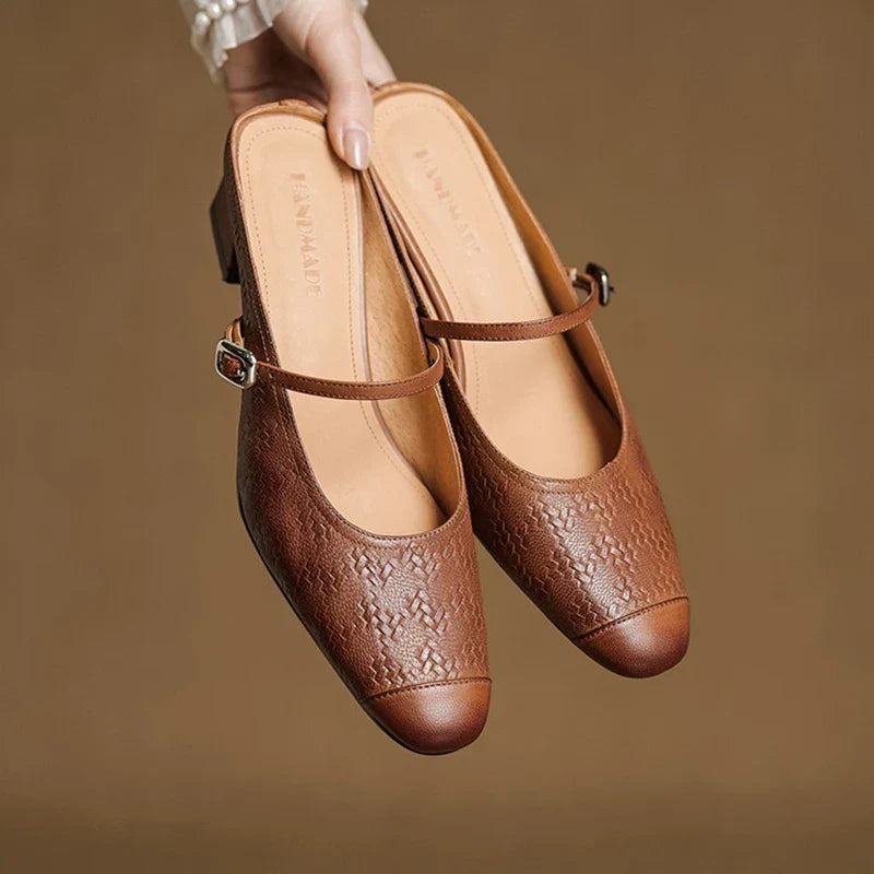 Brown embossed leather mule with square toe, adjustable buckle strap, and block heel