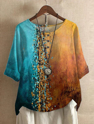 Women’s multicolor blouse, teal-to-gold gradient with speckled dot print, short sleeves.