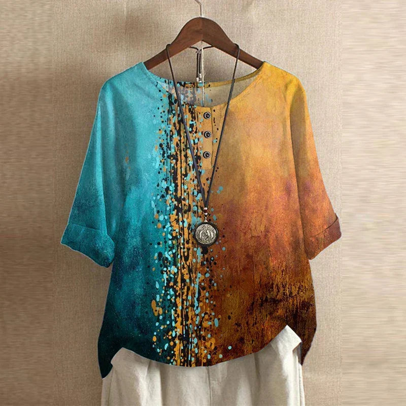 Women’s multicolor blouse, teal-to-gold gradient with speckled dot print, short sleeves.