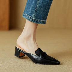 Black genuine leather mules with low block heel and slip-on loafer strap detail