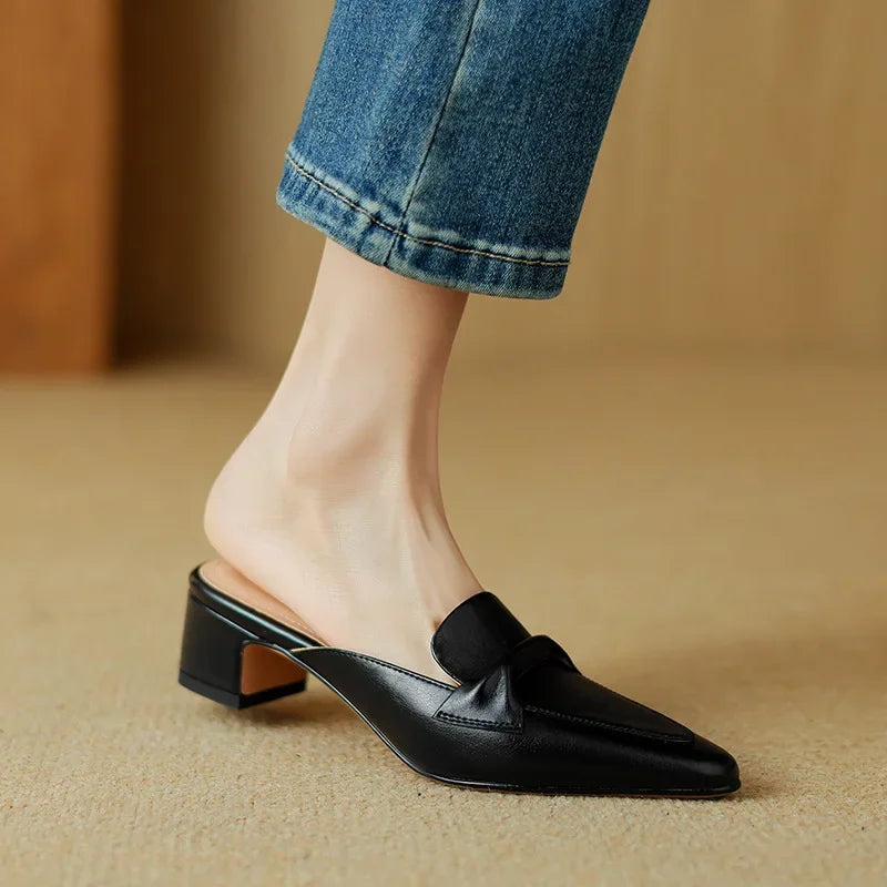Black genuine leather mules with low block heel and slip-on loafer strap detail