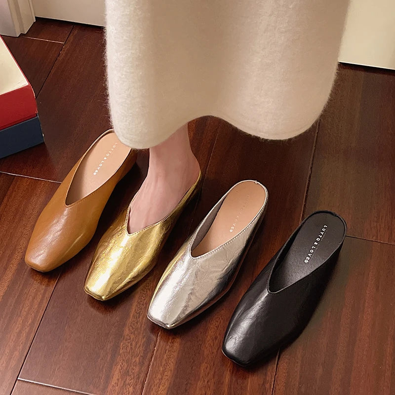 Set of pointed-toe mules in gold, silver, and black with low flat slip-on heels.