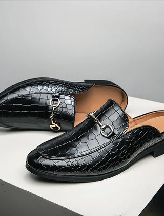 Black croc-embossed leather mules with metal-link bit strap and low block heel