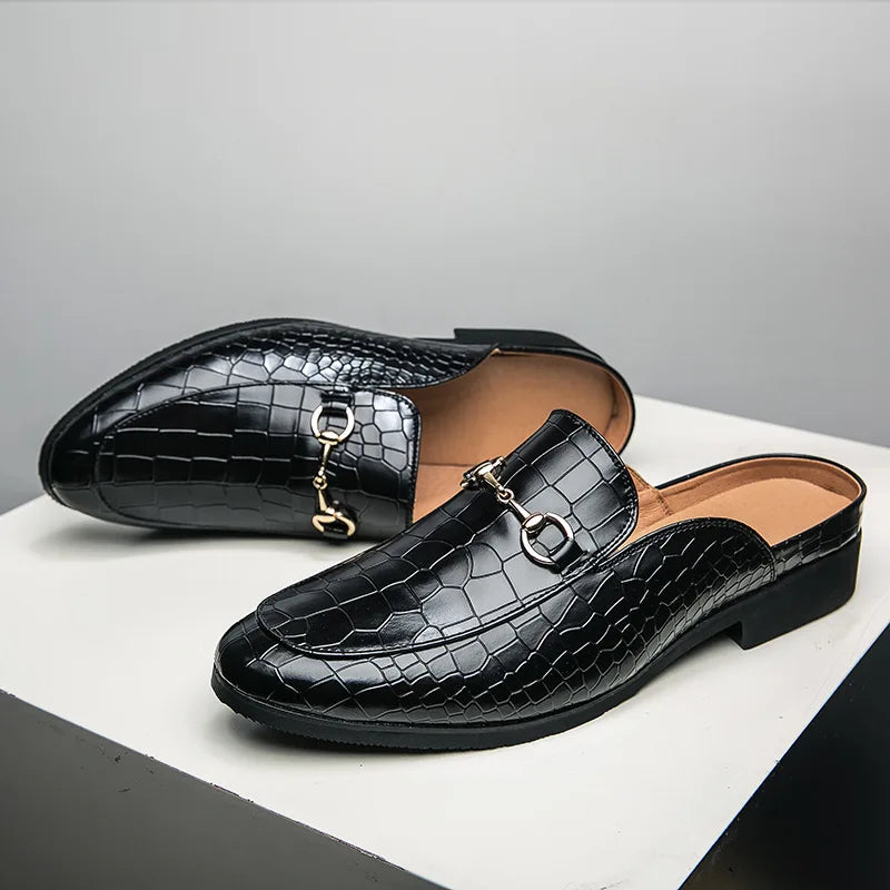 Black croc-embossed leather mules with metal-link bit strap and low block heel