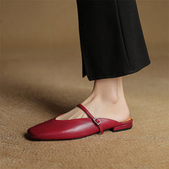 Maroon leather mules with open back and cross strap; buckle centered on top