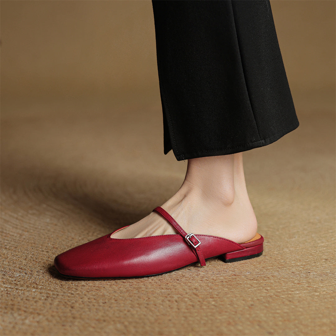 Maroon leather mules with open back and cross strap; buckle centered on top