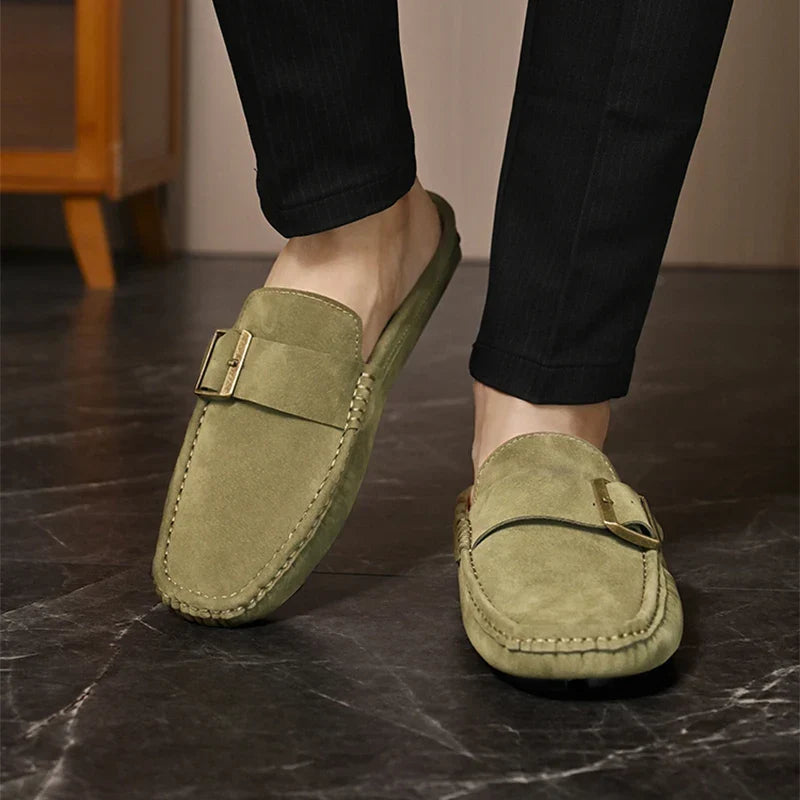 Olive green suede slip-on mules with square metal buckle strap and moc seam detail