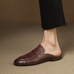 Brown leather mule with square-toe slip-on design and strap across the vamp