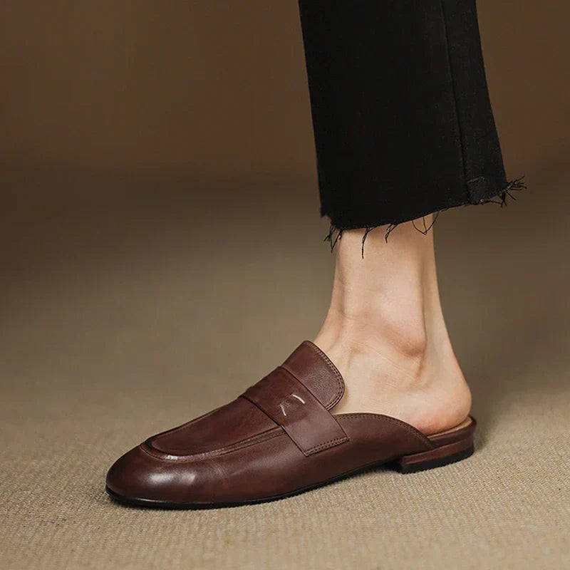 Brown leather mule with square-toe slip-on design and strap across the vamp