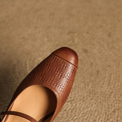 Brown embossed leather mule with cutout opening and single adjustable buckle strap
