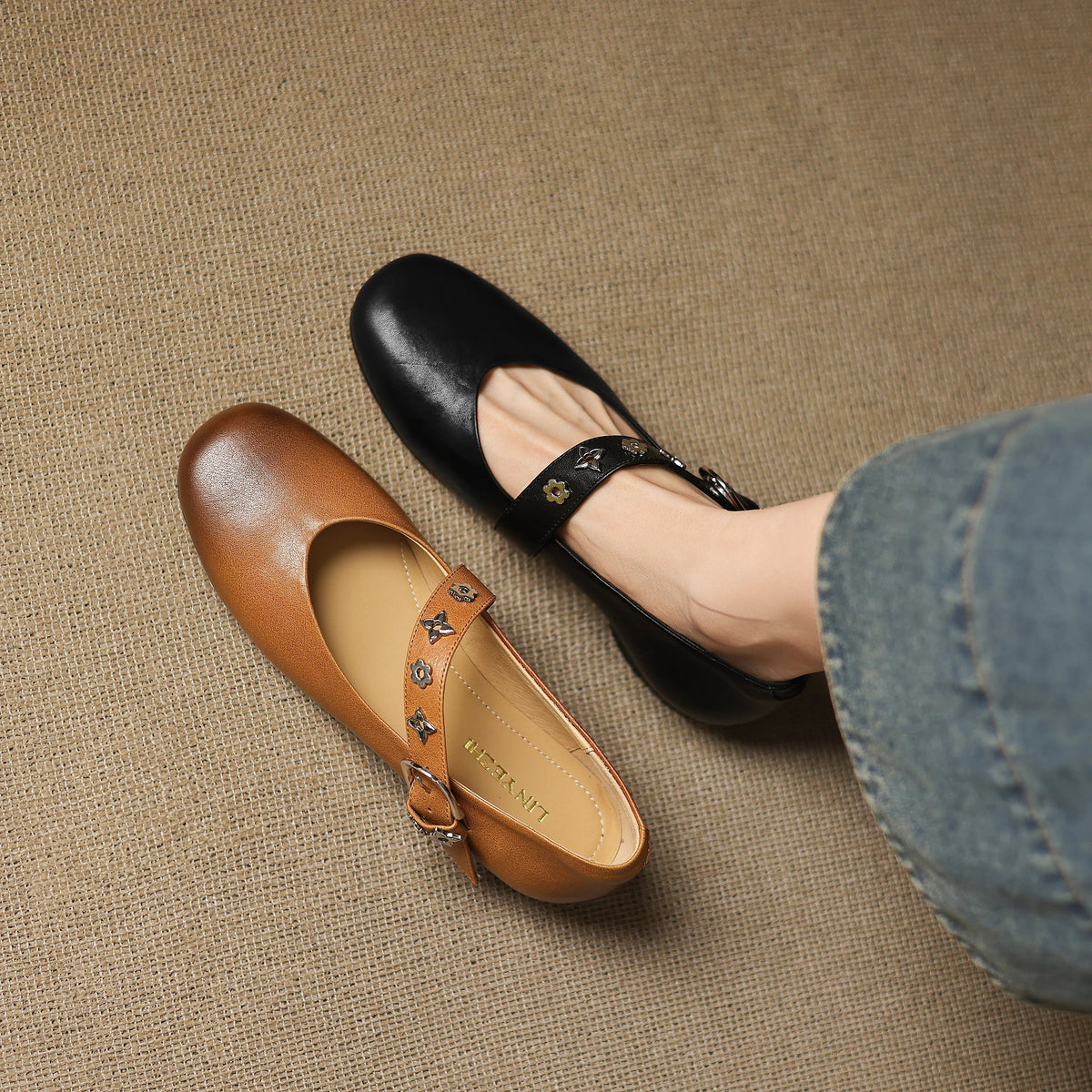 Khaki and black leather flats with patterned strap and buckle details