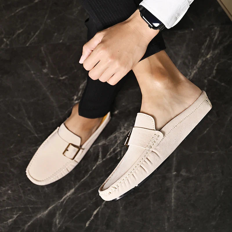 Cream suede mules with square buckle strap and stitched moc-toe edges