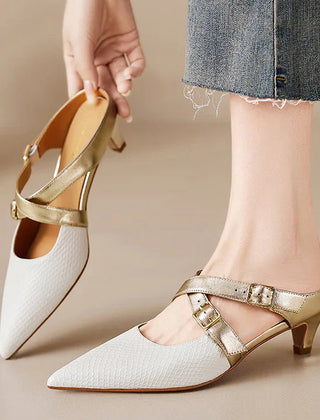 White textured leather mule with pointed toe, gold buckled straps, and low block heel.