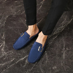 Blue suede mules with square buckle strap and moc-toe stitching