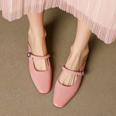 Pair of pink Mary Jane mules with elastic ankle strap and square buckle block heel