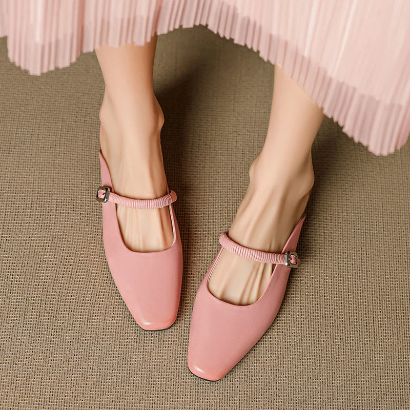 Pair of pink Mary Jane mules with elastic ankle strap and square buckle block heel