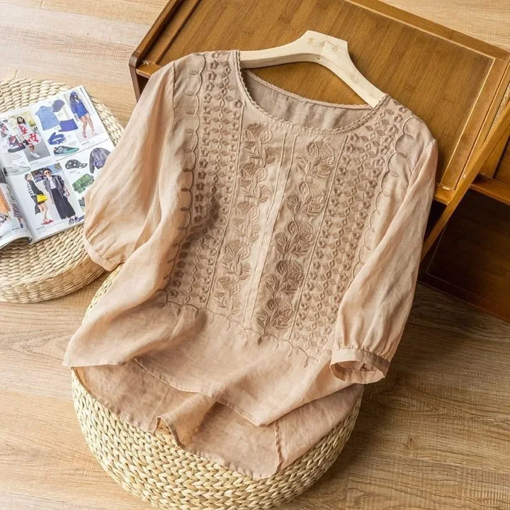 Beige elegant soft blouse with round neck, textured embroidered front, three-quarter sleeves