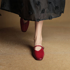 Maroon leather mules with slingback strap and small heel; worn with a skirt