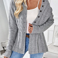 Gray ribbed cardigan with dark button front, long sleeves, and peplum hem