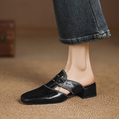 Black leather mule with square toe, strap across vamp, and low block heel