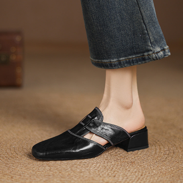 Black leather mule with square toe, strap across vamp, and low block heel