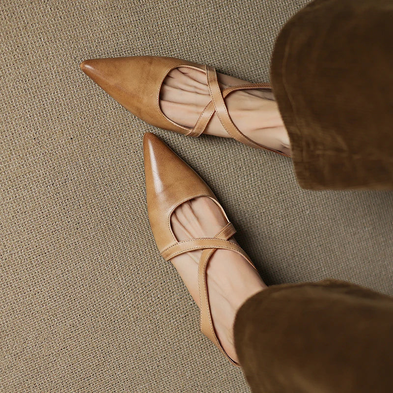 Tan leather mules with pointed toe and slingback strap, low heel detail view.