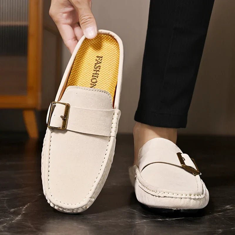Cream suede mule with square buckle strap and visible cushioned interior