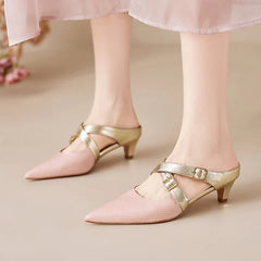 Pink textured leather mule sandals with pointed toe, gold straps, and low block heel.