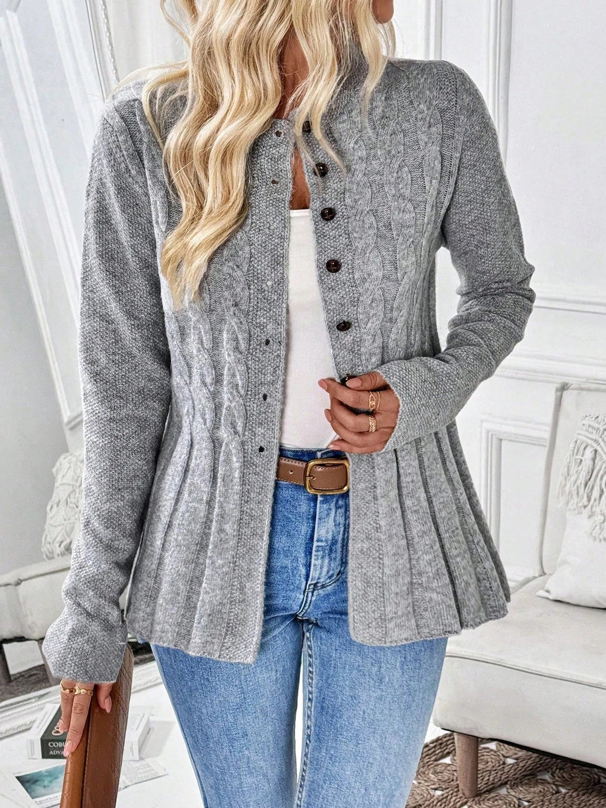 Gray ribbed cardigan with button front, long sleeves, and peplum hem