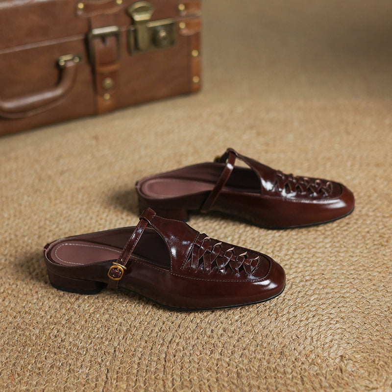 Two brown leather mules side view with braided upper and round gold buckle