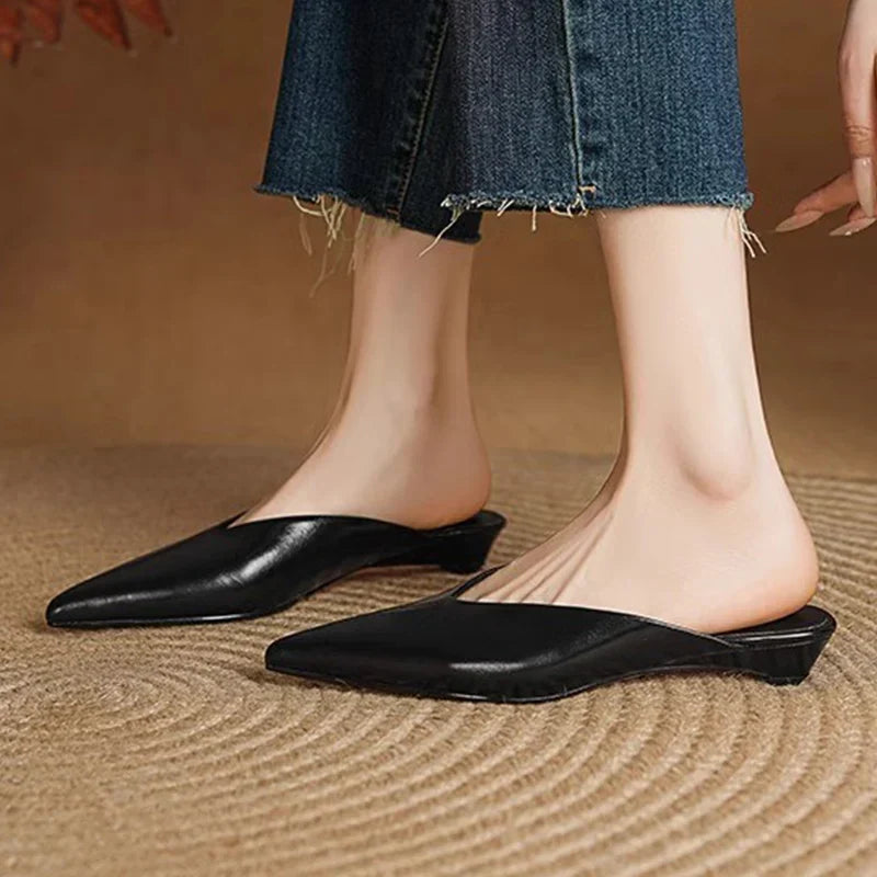 Black leather pointed-toe mules with low block heel.
