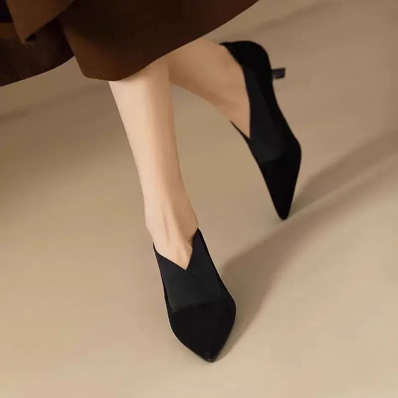 Black suede pointed-toe heeled pumps with slim heel and slip-on upper