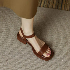 Brown leather platform sandals with open toe and ankle strap