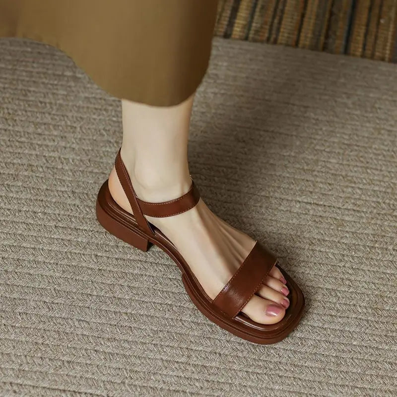 Brown leather platform sandals with open toe and ankle strap