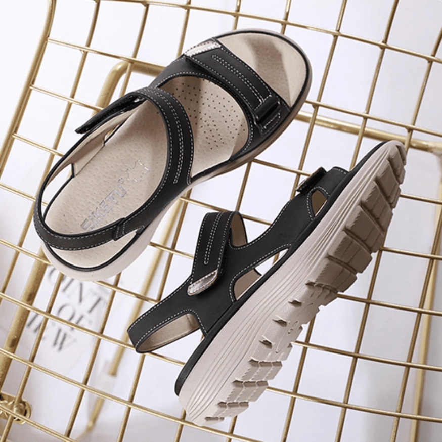 Black orthopedic sandals with two hook-and-loop straps and textured tread sole