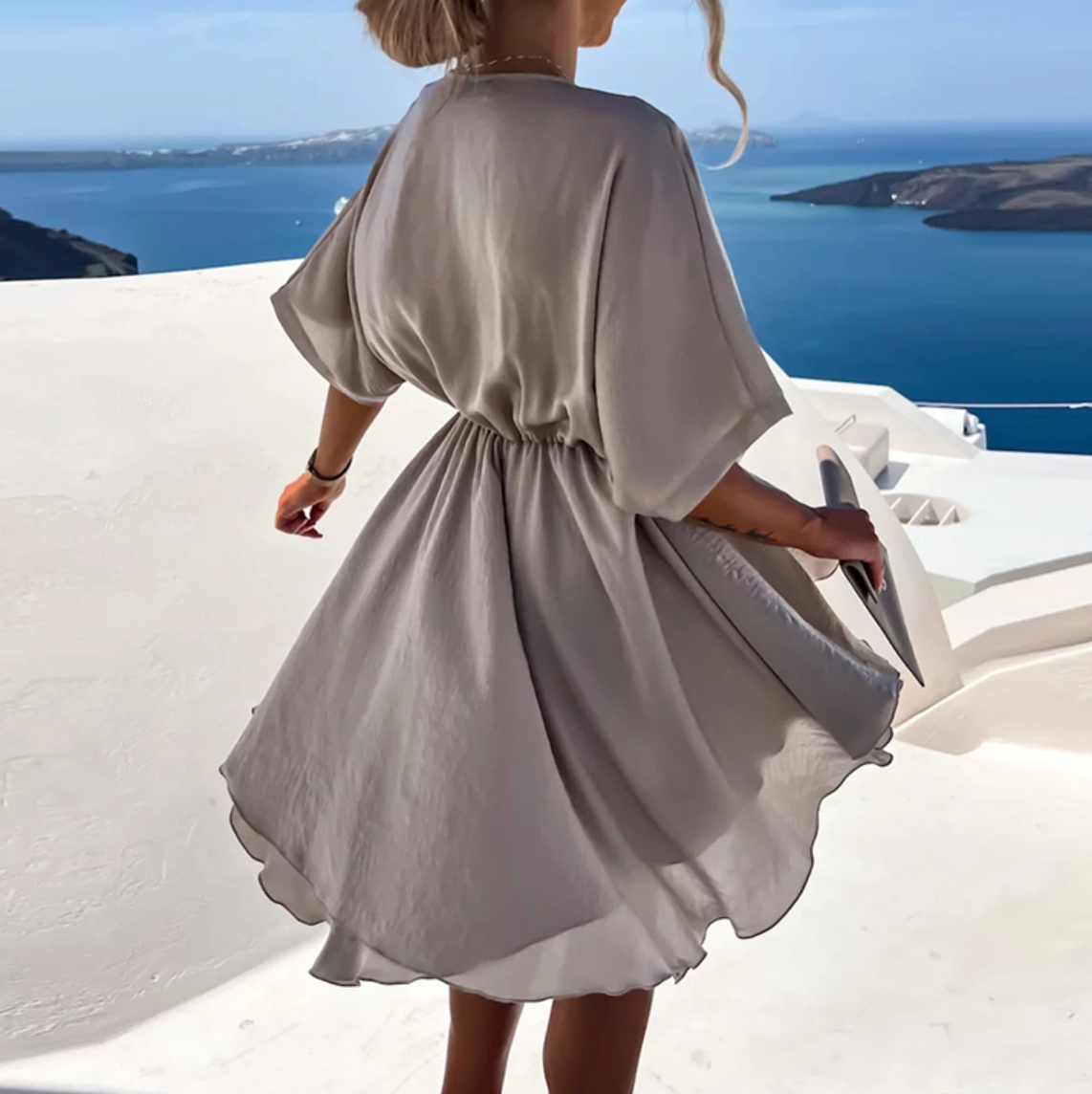 Taupe V-neck mini dress with belted waist and short wide sleeves (back view)