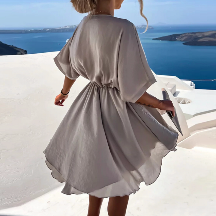 Taupe V-neck mini dress with belted waist and short wide sleeves (back view)