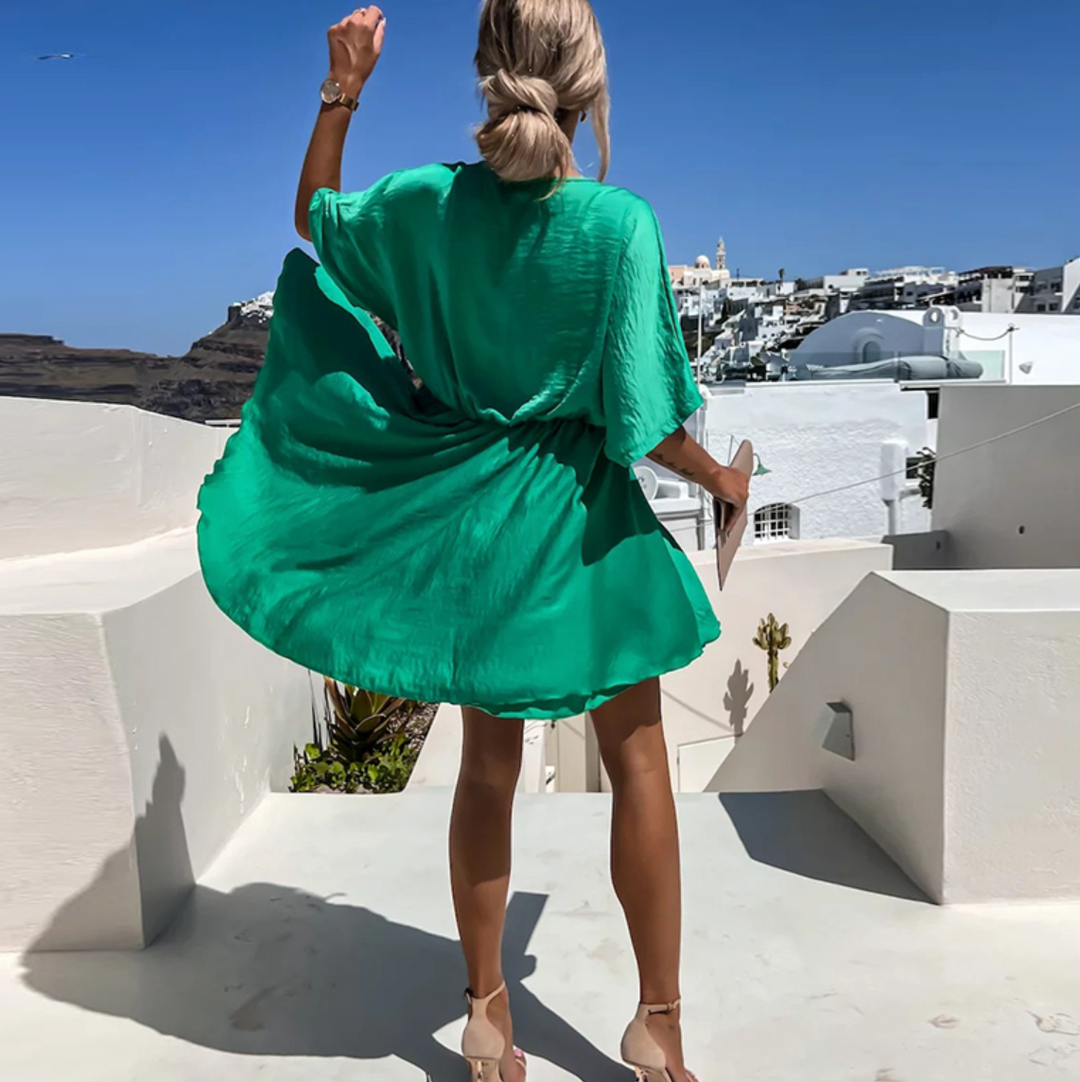 Green V-neck mini dress with belted waist and short flutter sleeves (back view)