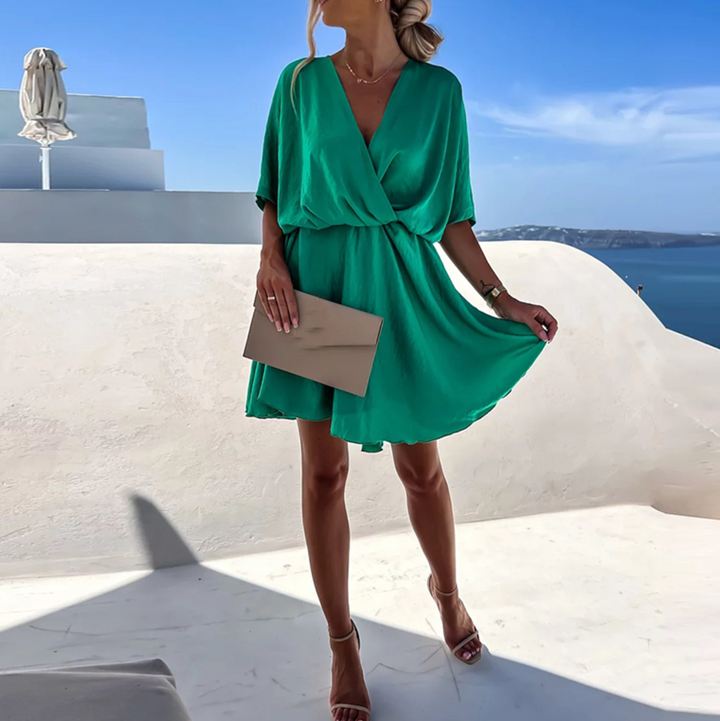 Dark green V-neck mini dress with tie waist and short flutter sleeves