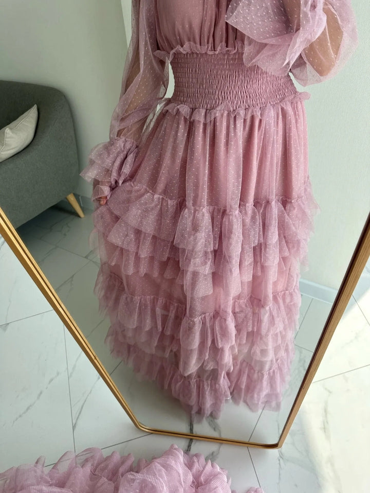 Pink sheer tiered ruffle dress on model, textured layered skirt hem