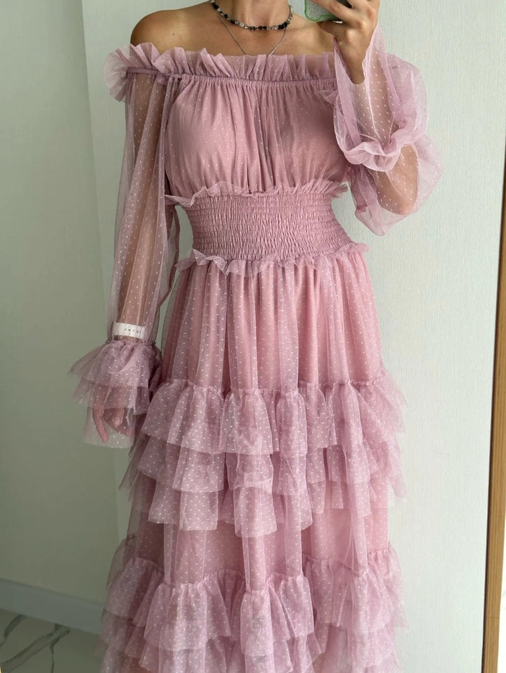 Pink sheer off-shoulder tiered ruffle dress on model, long puff sleeves