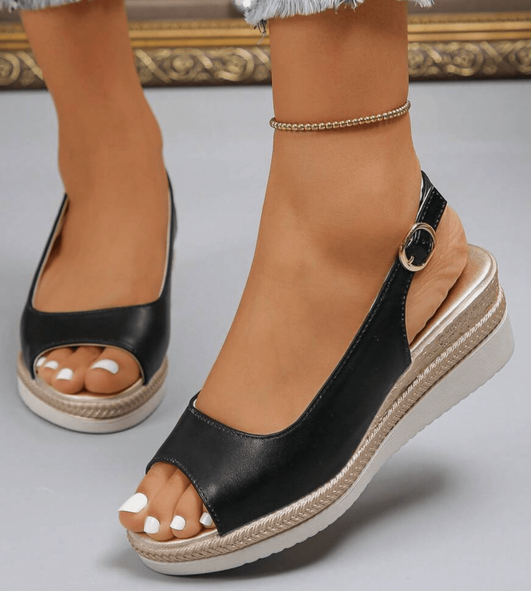 Black orthopedic sandals with open toe and ankle strap buckle, cushioned wedge platform.