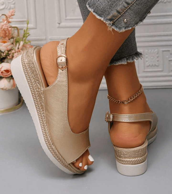 Gold orthopedic sandals with ankle strap buckle and open toe, cushioned wedge heel.