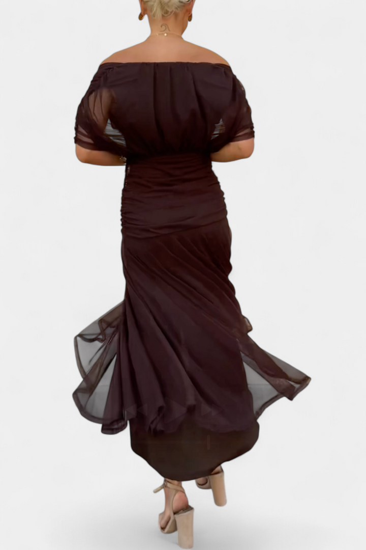 Brown off-shoulder ruched midi dress from back view with gathered fabric and sheer skirt panels