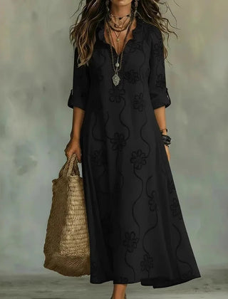 Black maxi dress with short sleeves and subtle floral pattern, V-neck.