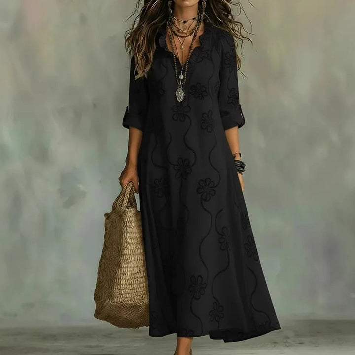 Black maxi dress with short sleeves and subtle floral pattern, V-neck.